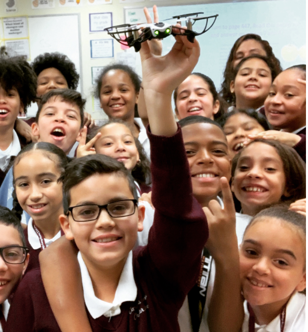 Happy children in a STEM drone curriculum program.