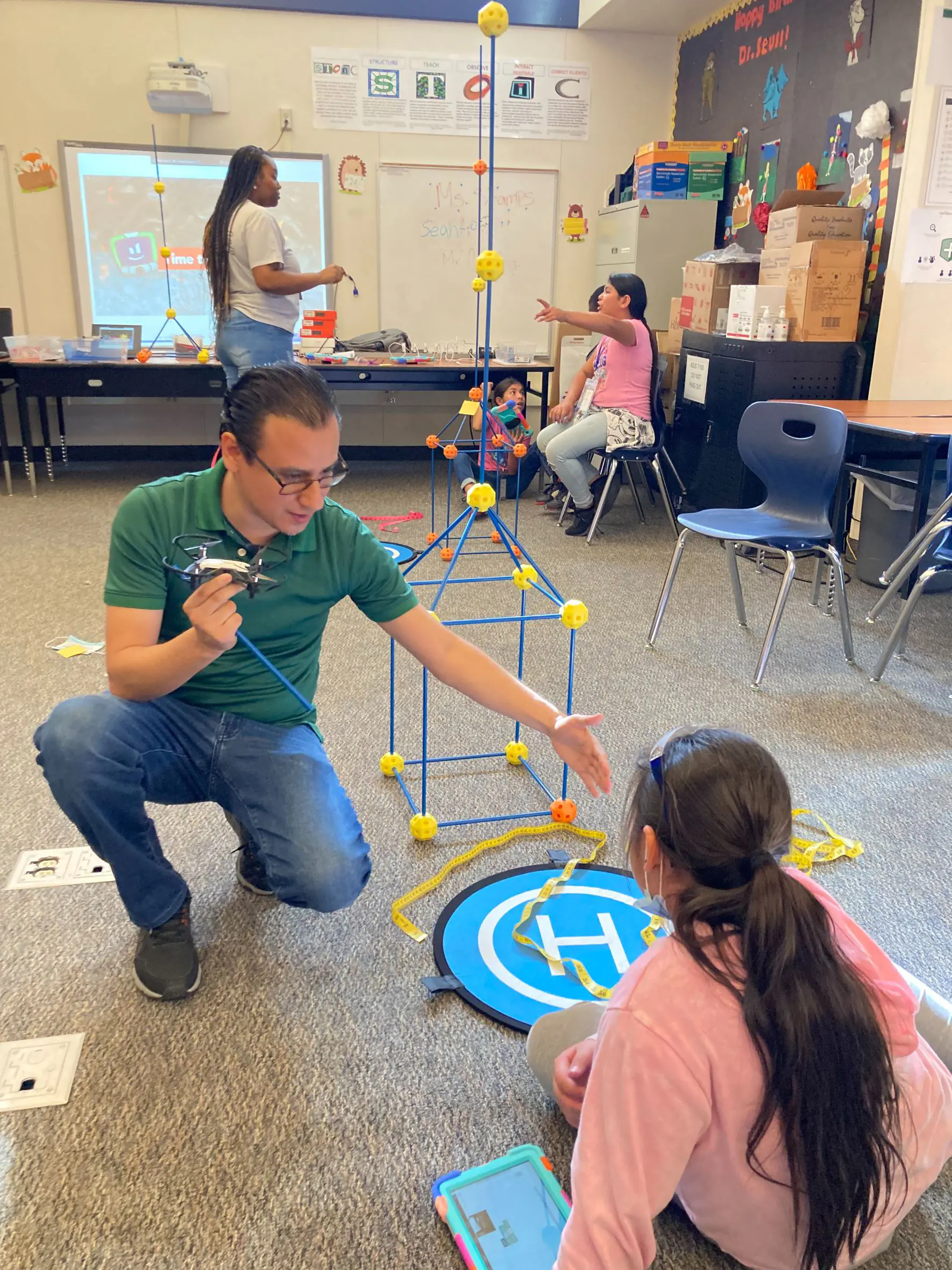 Teacher showing student a drone